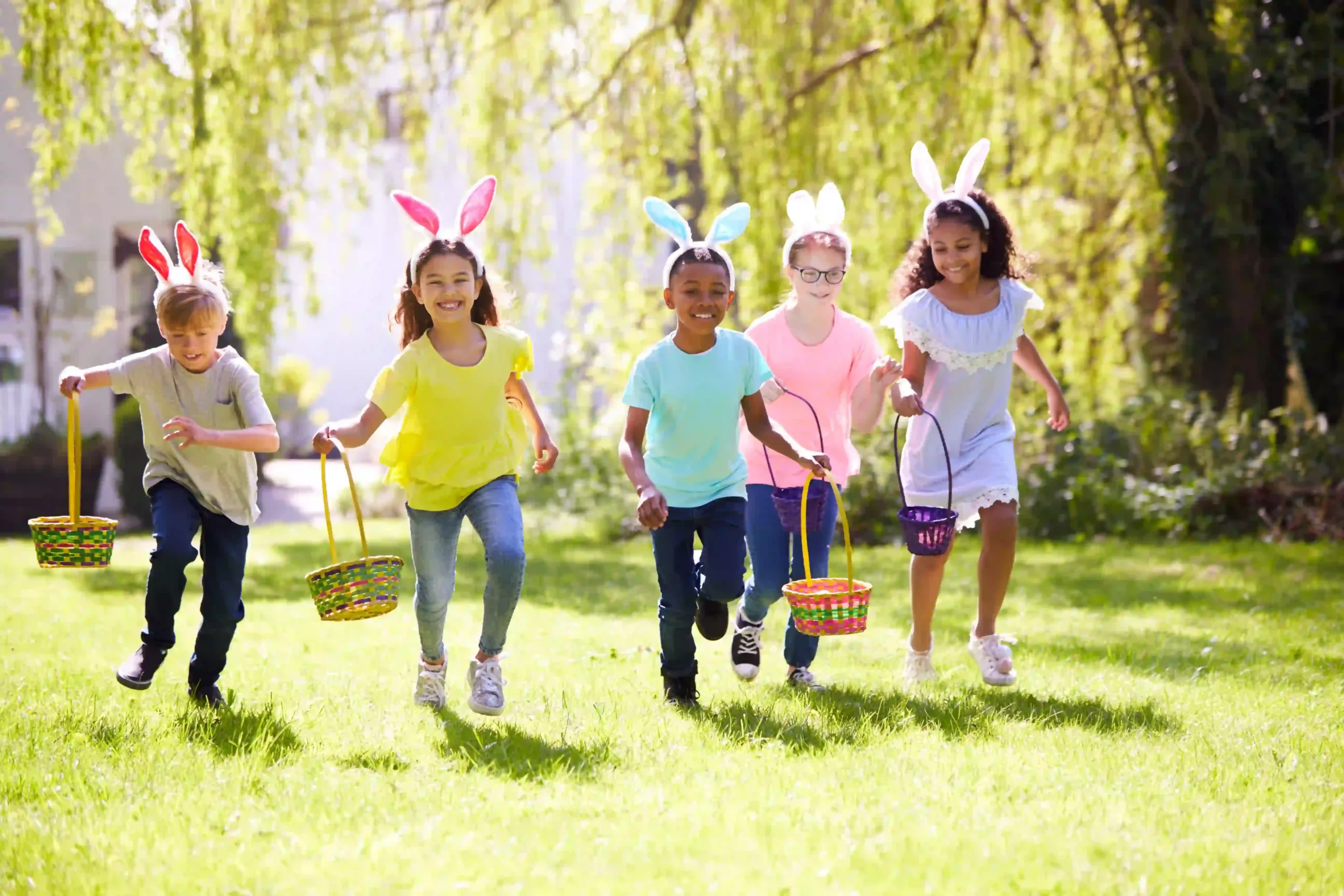 Group of children on an Easter egg hunt in the sun.